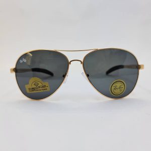 عکس از عینک دودی خلبانی برند ریبن با فریم طلایی رنگ و عدسی آنتی رفلکس و دسته فنری مدل RB8329