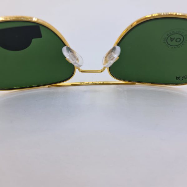 عکس از عینک آفتابی با شیشه نشکن برند ao با فریم فلزی طلایی و عدسی سبز مدل cao2