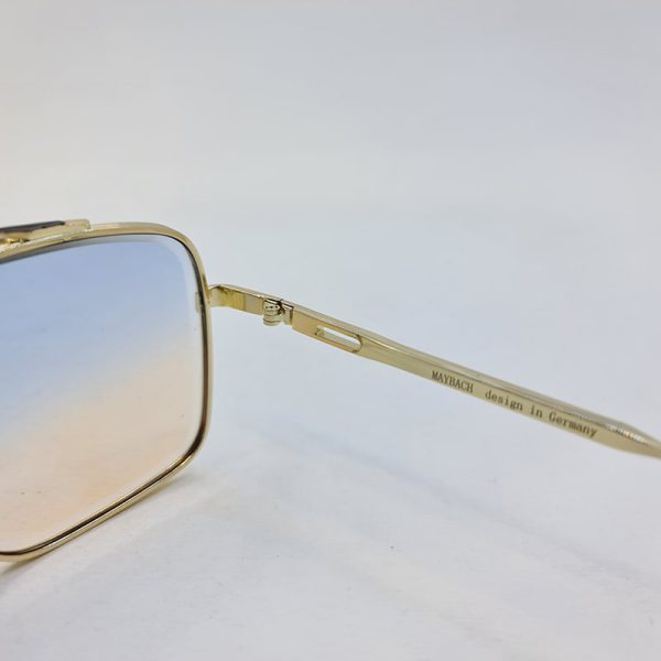 عکس از عینک شب با لنز دو رنگ آبی و قهوه ای و فریم طلایی برند میباخ مدل o2001