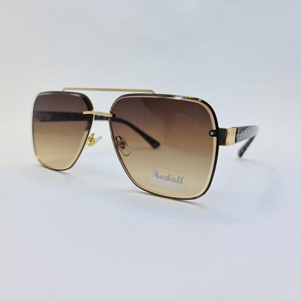 عکس از عینک آفتابی aedoll با فریم طلایی، عدسی قهوه ای و دسته طرح فندی مدل dk01