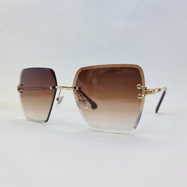 عکس از عینک آفتابی فریملس برند ditiai با لنز هایلایت قهوه ای و دسته طلایی مدل 9530
