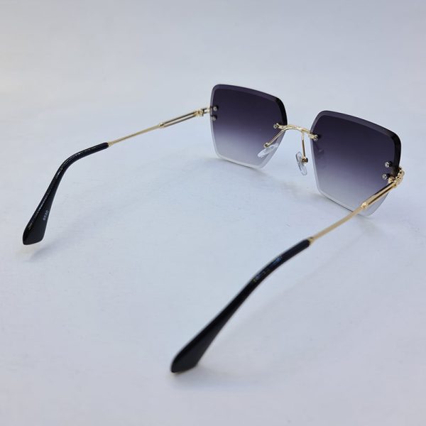 عکس از عینک آفتابی بدون فریم برند ditiai با لنز هایلایت دودی و دسته طلایی مدل 9530