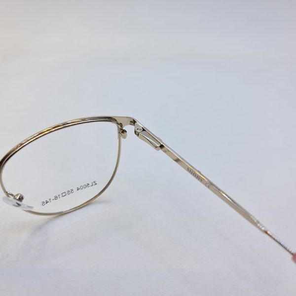 عکس از عینک طبی گرد طلایی و صورتی رنگ با دسته فنری و فریم فلزی مدل 5004
