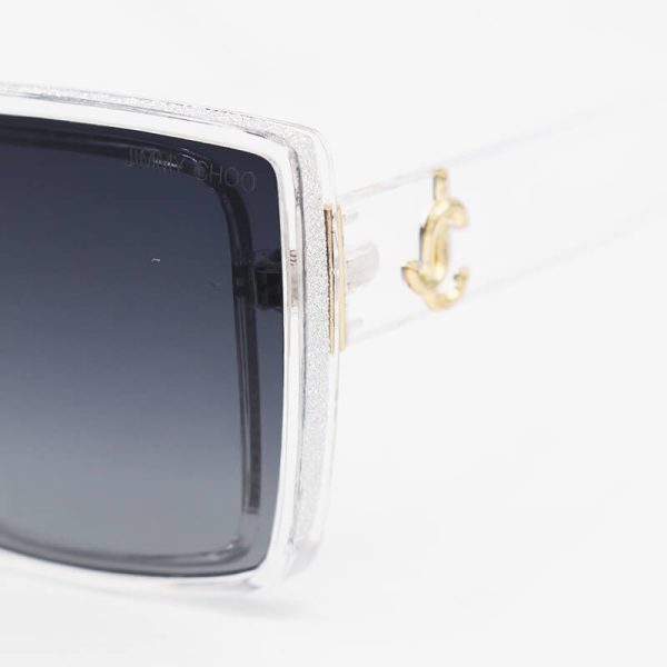 عکس از عینک آفتابی jimmy choo شاین دار، با فریم بی رنگ و شفاف و لنز تیره مدل 7223