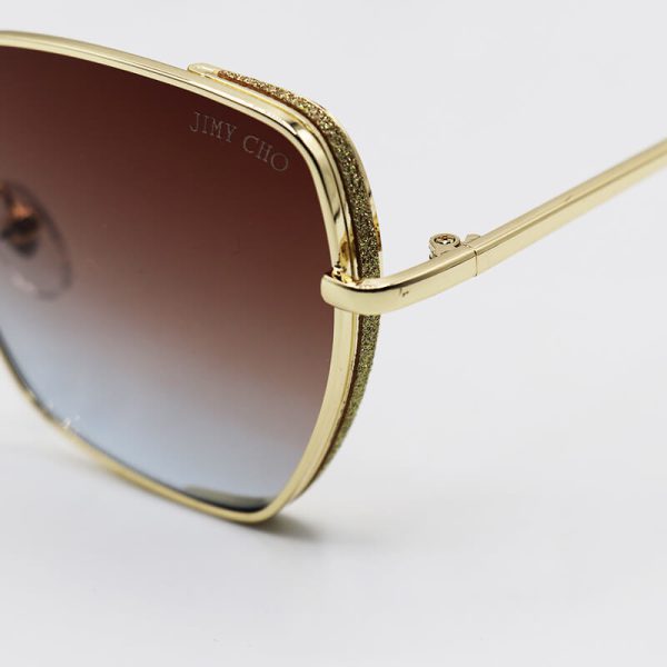 عکس از عینک آفتابی زنانه شاین دار با فریم طلایی و لنز دو رنگ سایه روشن مدل 28017