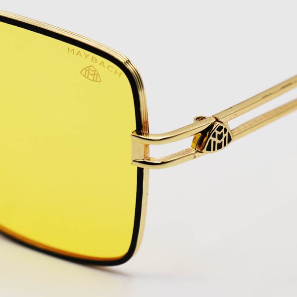 عکس از عینک دید در شب میباخ با فریم طلایی و مشکی رنگ، مربعی شکل و لنز زرد مدل h5621