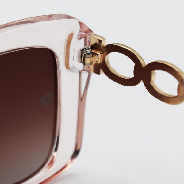 عکس از عینک آفتابی زنانه ورساچه با فریم عسلی، دسته صورتی و طلایی و لنز پلاریزه و قهوه ای مدل 3322