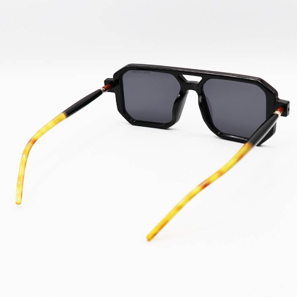 عکس از عینک آفتابی با فریم مشکی رنگ، مربعی شکل، دسته لوله ای و لنز دودی تیره مارک جیکوبز مدل 8709