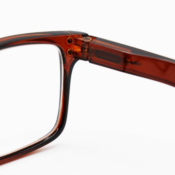 عکس از عینک مطالعه نزدیک بین با عدسی سنگ و شیشه ای، فریم قهوه ای رنگ، مستطیلی و دسته فنری مدل 711