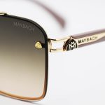 عکس از عینک آفتابی طلایی Maybach با فریم چندضلعی، دسته کرمی و لنز قهوهای سایه روشن مدل 22384