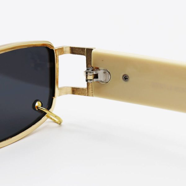 عکس از عینک آفتابی طلایی جنتل مانستر مستطیلی شکل، پیرسینگ دار، دسته کرمی و لنز دودی تیره مدل 8032