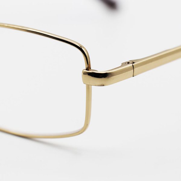 عکس از عینک مطالعه نزدیک بین با فریم طلایی، از جنس فلزی، دسته فنری و لنز آنتی رفلکس مدل dnm-0001