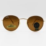 عکس از عینک آفتابی گرد RAY-BAN با فریم فلزی، طلایی رنگ، عدسی سنگ و قهوه ای تیره مدل 3447