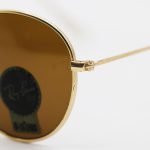 عکس از عینک آفتابی گرد RAY-BAN با فریم فلزی، طلایی رنگ، عدسی سنگ و قهوه ای تیره مدل 3447