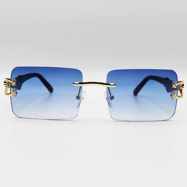 عکس از عینک آفتابی فریم لس cartier با عدسی آبی سایه روشن، دسته چوبی و طرح یوزپلنگ مدل 7288