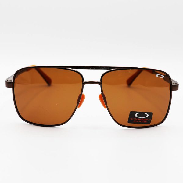عکس از عینک آفتابی اوکلی با فریم چندضلعی، رنگ مسی، عدسی قهوه ای تیره و پلاریزه مدل 008922