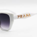 عکس از عینک آفتابی زنانه PRADA با فریم پروانه ای، سفید رنگ و لنز دودی هایلایت مدل 2837