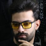 عکس از عینک شب Diesel با فریم مشکی مات، مستطیلی، دسته چوبی، رنگ قهوه‌ای و لنز پلاریزه و زرد رنگ مدل P5320 بر روی صورت محمدحسین ابراهیم زاده