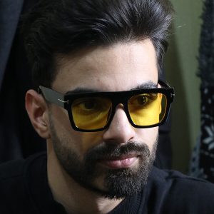 عکس از عینک دید در شب تام فورد با فریم مربعی شکل، رنگ مشکی براق و لنز زرد رنگ مدل E5083 بر روی صورت محمدحسین ابراهیم زاده