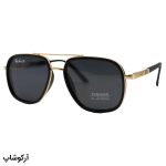 عکس از عینک آفتابی Ray-Ban با فریم مشکی و طلایی، شکل چند ضلعی، دسته فنری و لنز دودی تیره و پلاریزه مدل P9004
