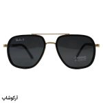 عکس از عینک آفتابی Ray-Ban با فریم مشکی و طلایی، شکل چند ضلعی، دسته فنری و لنز دودی تیره و پلاریزه مدل P9004
