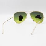 عکس از عینک آفتابی Ray-Ban با فریم خلبانی، رنگ طلایی، لنز سنگ و سبز تیره و سایه روشن مدل RB3026 HQ